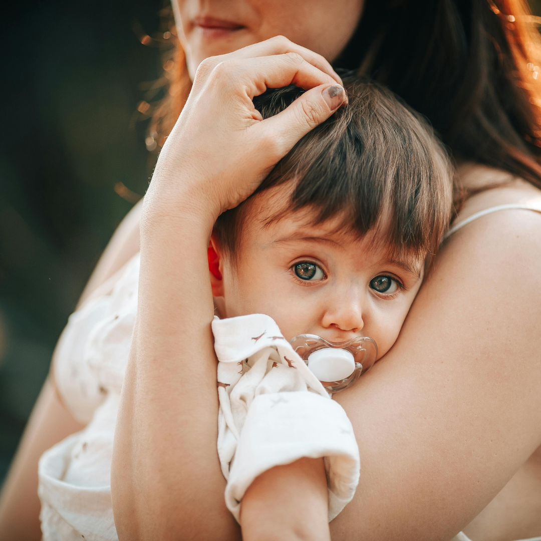 baby or toddler with pacifier in their mouth
