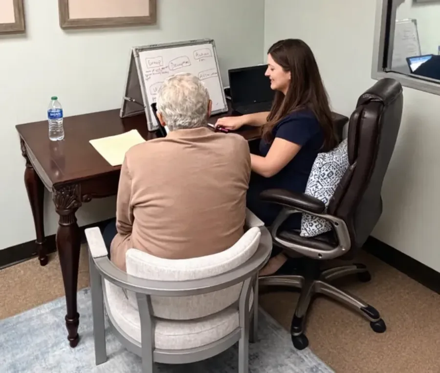 Speech therapist working with an adult client during a therapy session